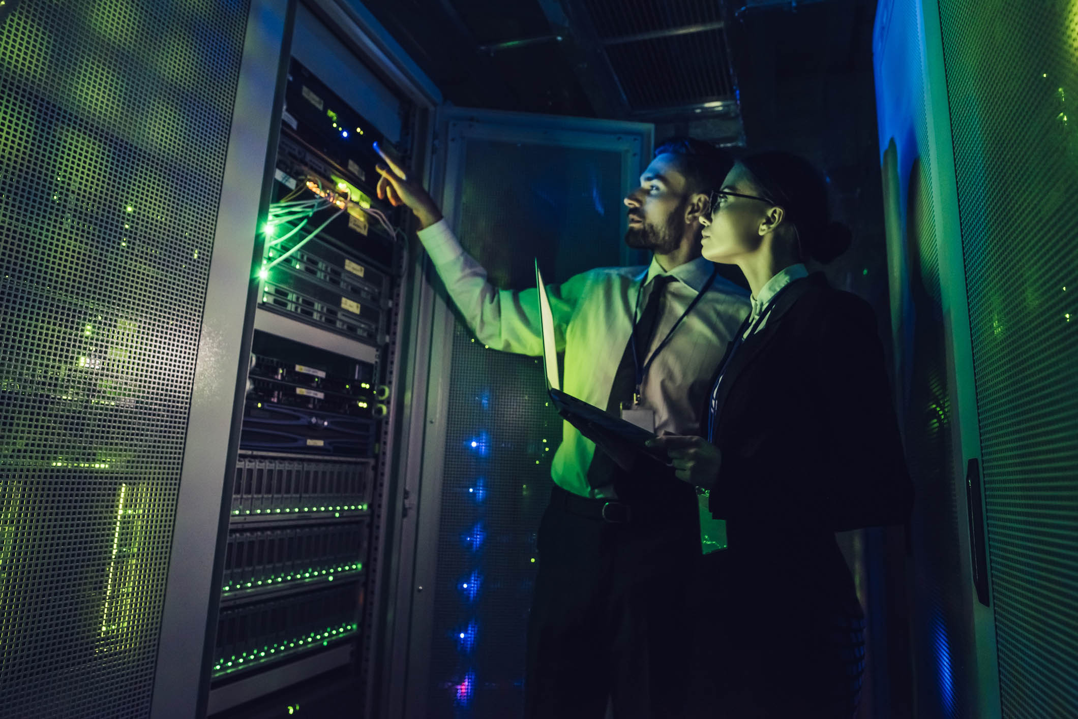 Handsome man and attractive woman are working in data centre